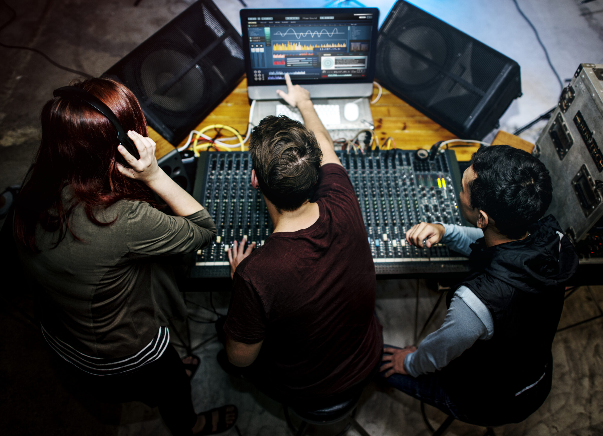 Group of people at a sound mixer station